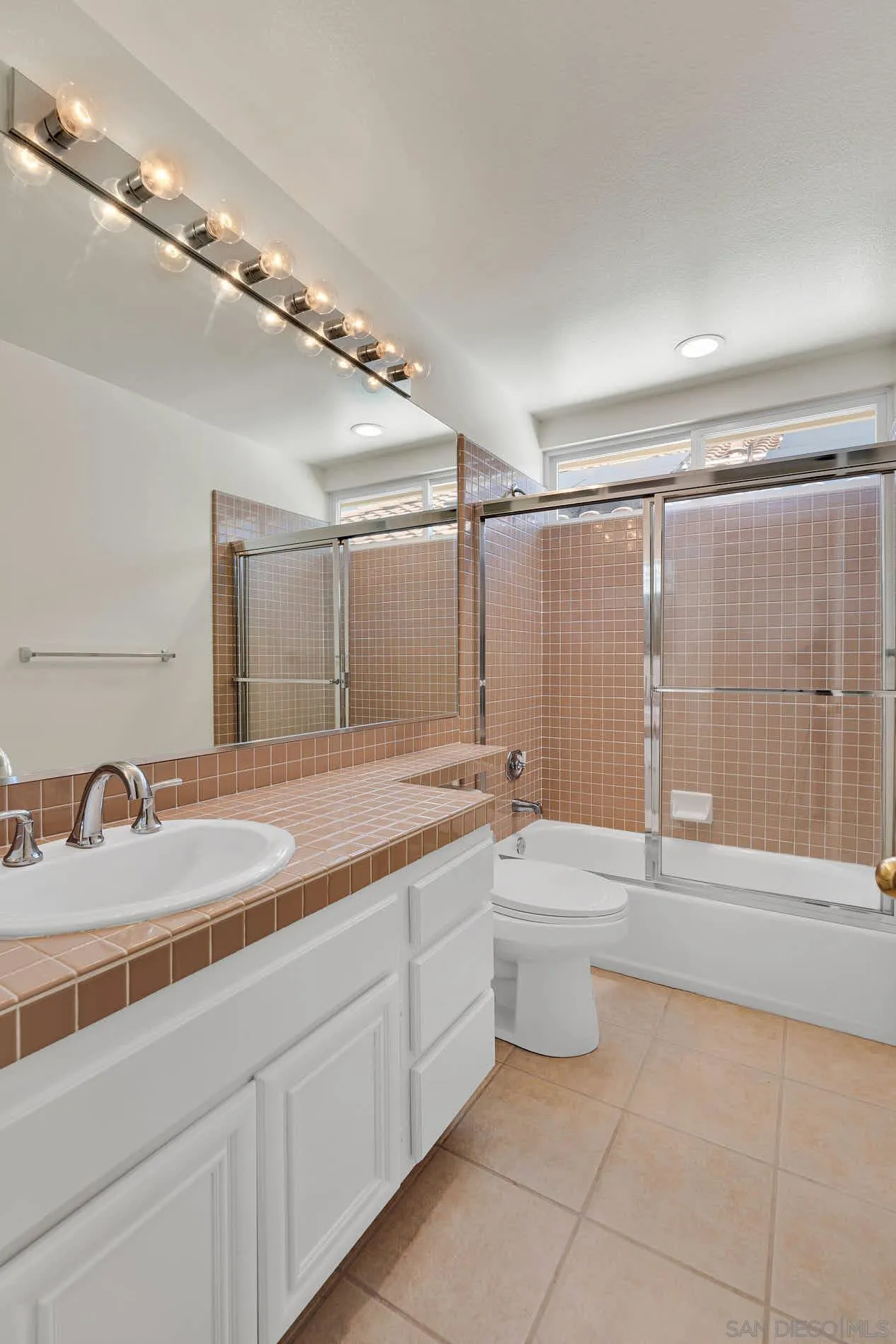 45441 Camino Monzon Temecula, CA 92592 - Photo 42 of 53 a bathroom with a granite countertop sink a toilet a mirror and shower