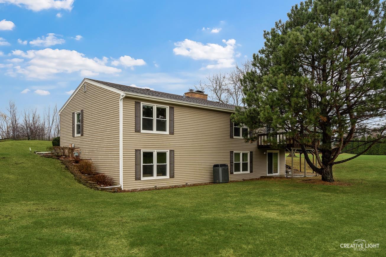 11N638 Old Barn Road Elgin, IL 60124 - Photo 20 of 26 a front view of a house with a garden