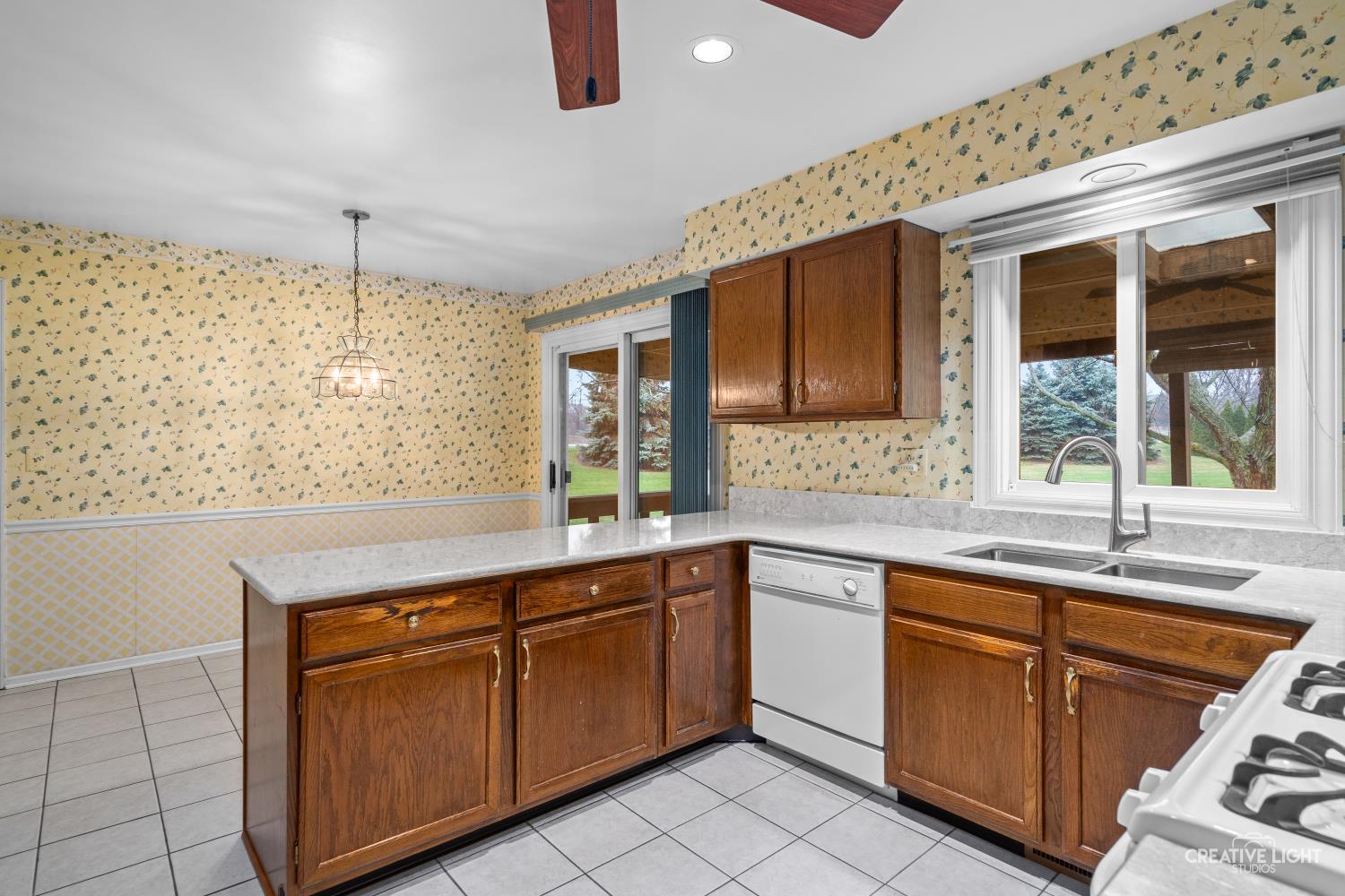 11N638 Old Barn Road Elgin, IL 60124 - Photo 6 of 26 a kitchen with sink cabinets and window
