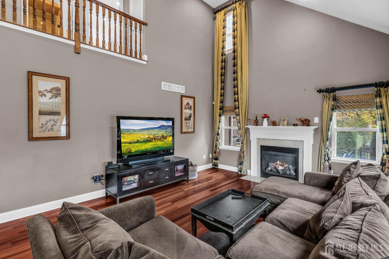 26 Cannon Road Old Bridge, NJ 08857 - Photo 24 of 39 a living room with furniture a flat screen tv and a fireplace