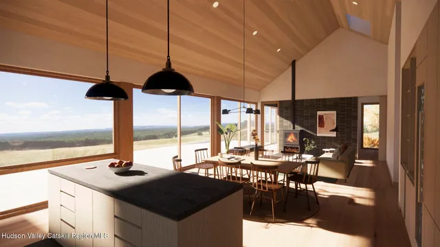 a kitchen with a stove a sink a counter top space and living room view