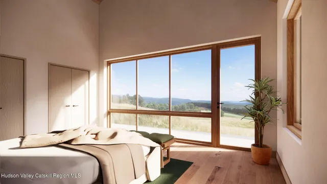 a bedroom with a bed and a large window with wooden floor