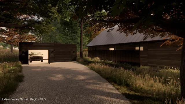 a view of back yard of the house and cars parked