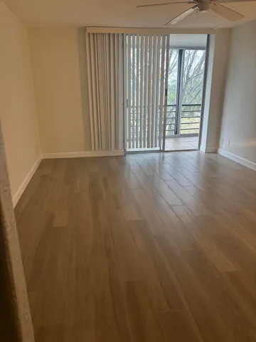 a view of wooden floor and brick wall