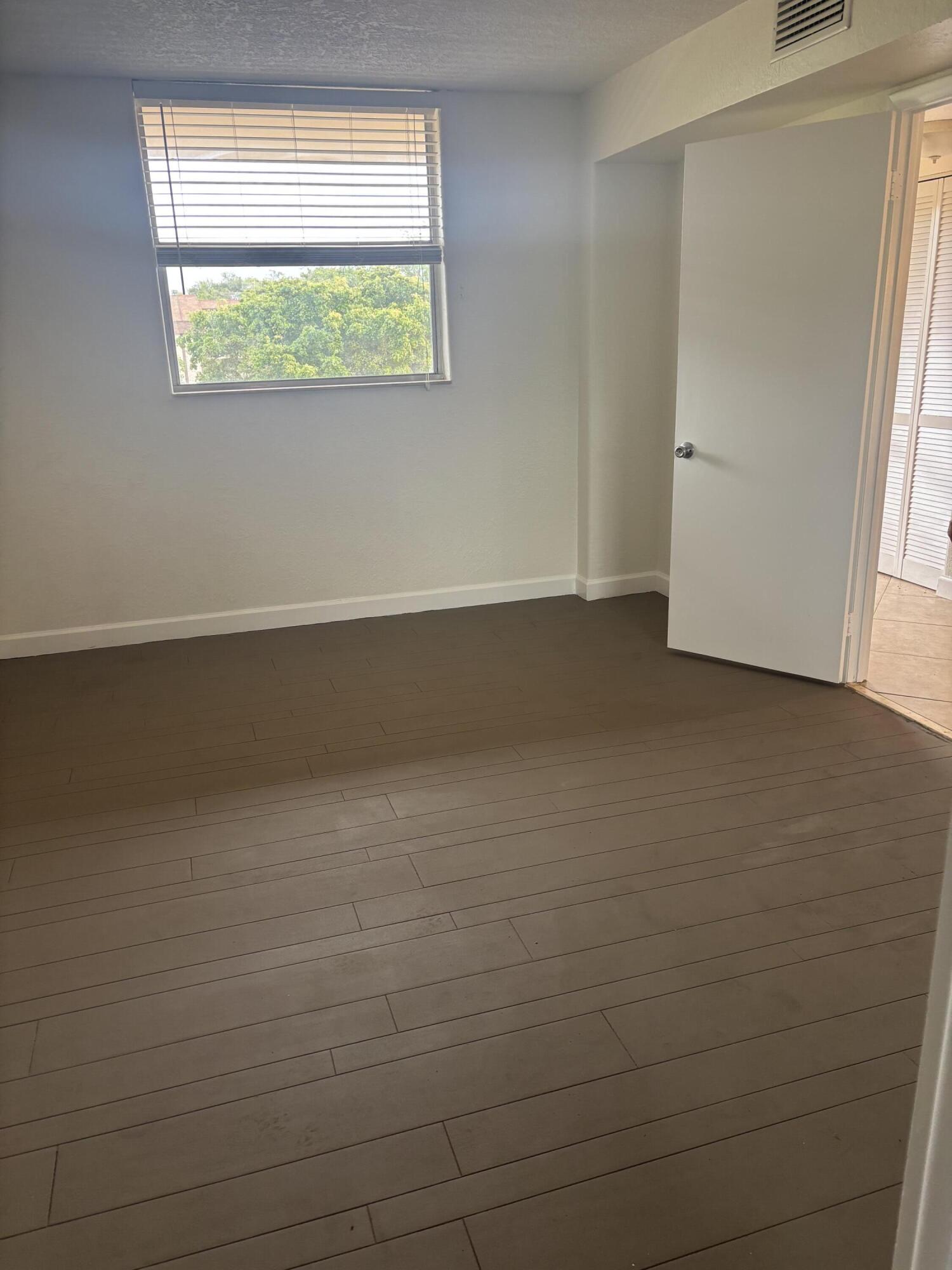 6461 Northwest 2nd Avenue, Unit 313 Boca Raton, FL 33487 - Photo 7 of 9 an empty room with a window