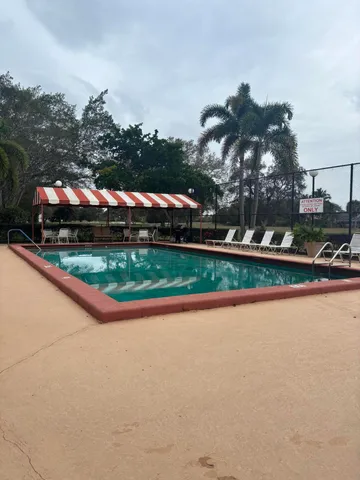 front view of house with a yard and potted plants