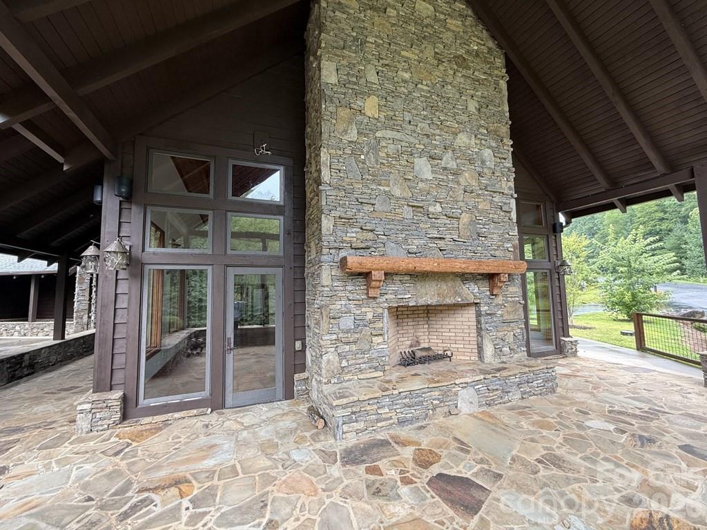 Lot 6 Garnet Road Sylva, NC 28779 - Photo 6 of 9 a view of empty room with a fireplace and a floor to ceiling window