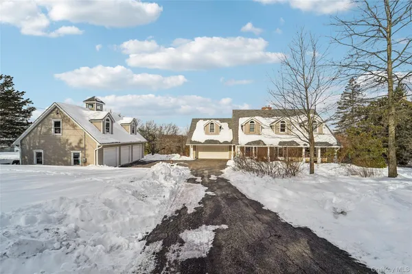 a view of a large house with a snow in the background