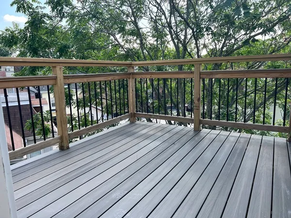 a view of balcony with wooden floor and fence
