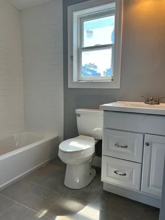 a bathroom with a sink a toilet and bathtub
