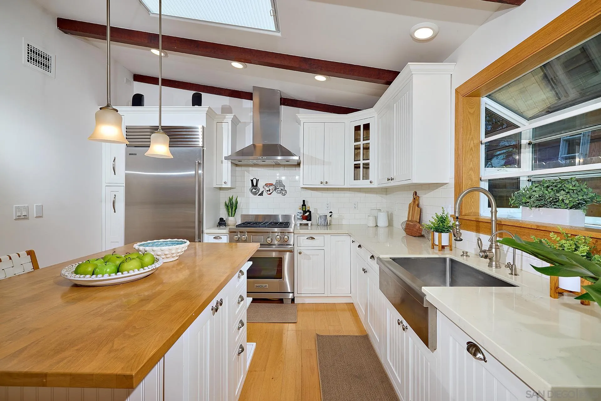 211 La Mesa Avenue Encinitas, CA 92024 - Photo 11 of 53 a kitchen with a sink a stove and wooden floor