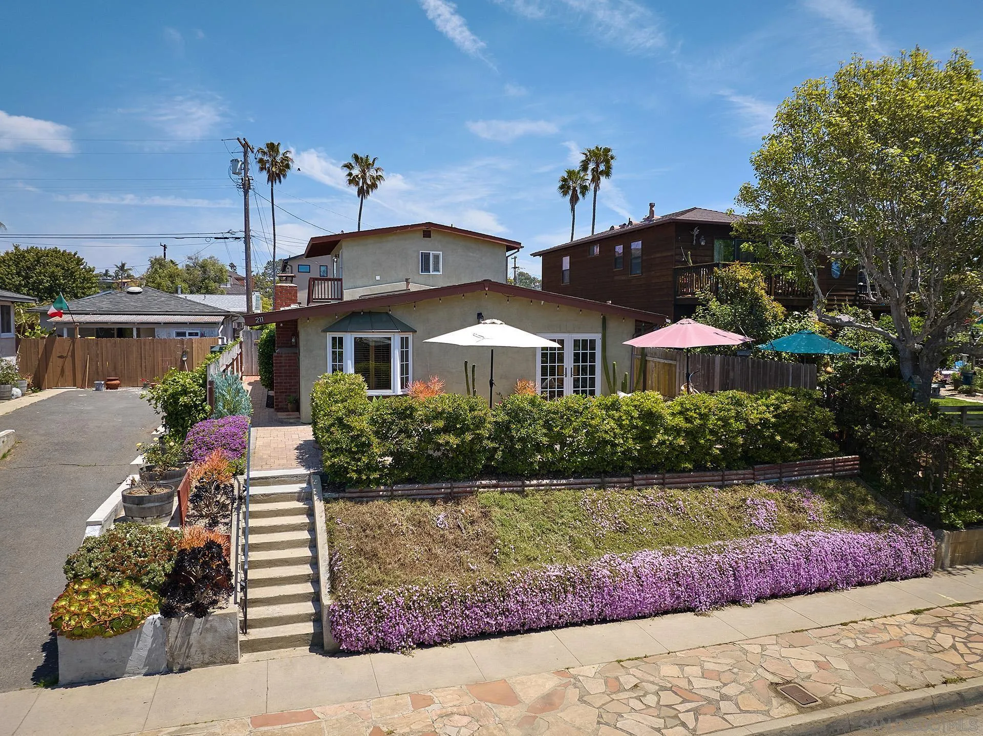 211 La Mesa Avenue Encinitas, CA 92024 - Photo 53 of 53 a front view of a house with a yard and potted plants