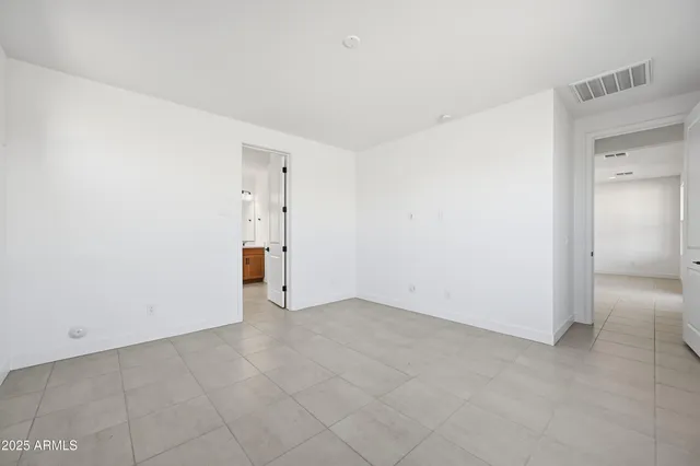 an empty room with windows and entrance