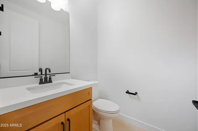 a spacious bathroom with a double vanity sink a mirror a bathtub and shower
