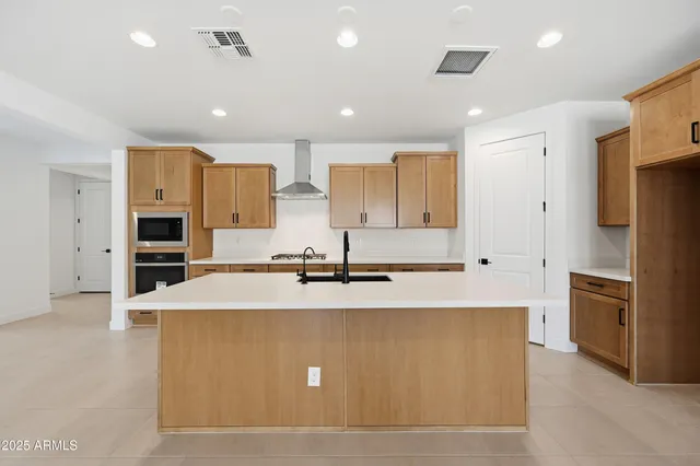 a kitchen with stainless steel appliances granite countertop a sink and a stove