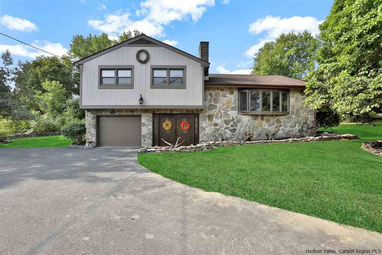 17 Deller Road Highland, NY 12528 - Photo 1 of 33 a front view of a house with a garden and plants