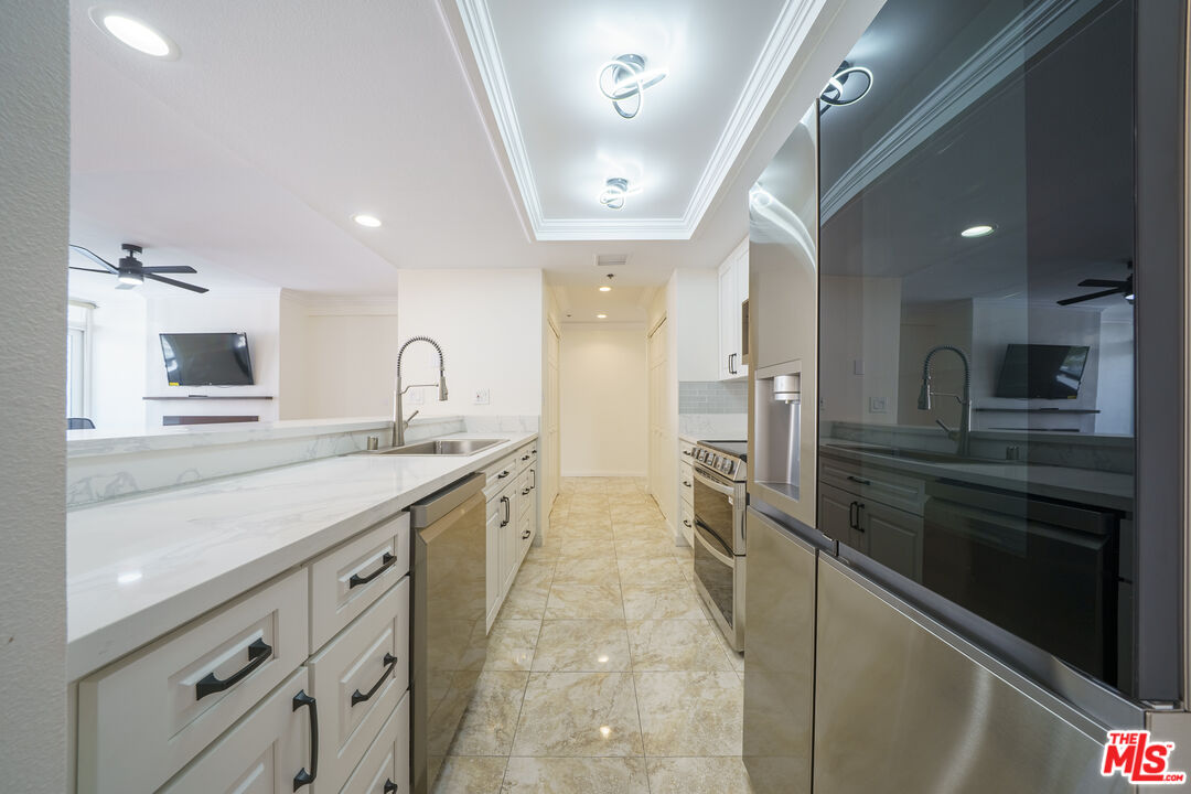 600 West 9th Street, Unit 1502 Los Angeles, CA 90015 - Photo 6 of 37 a large kitchen with granite countertop a large counter top stainless steel appliances and cabinets