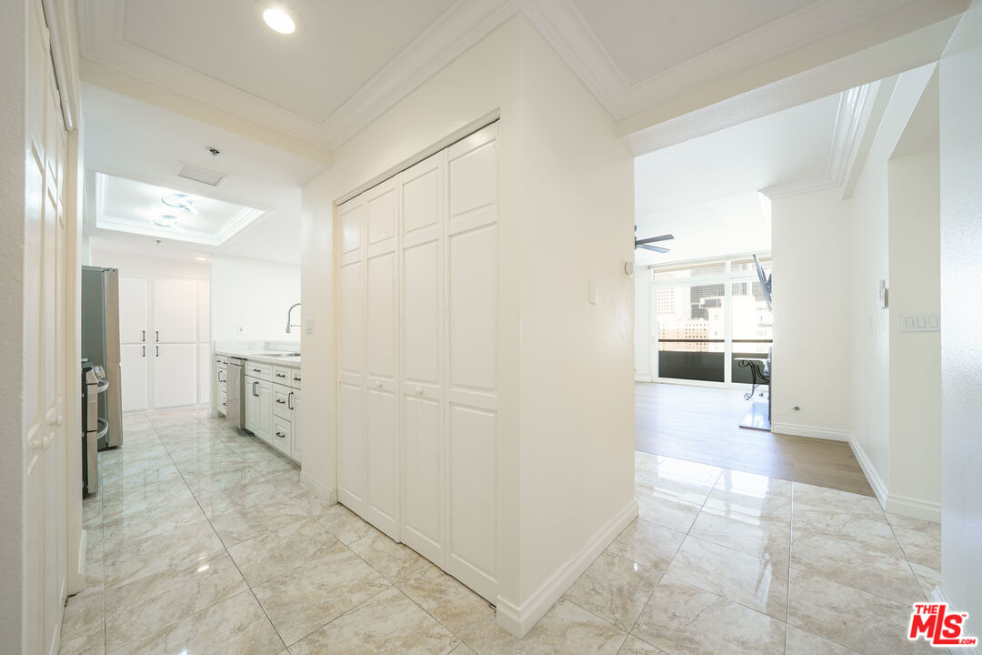 600 West 9th Street, Unit 1502 Los Angeles, CA 90015 - Photo 7 of 37 a view of a hallway with wooden shelves