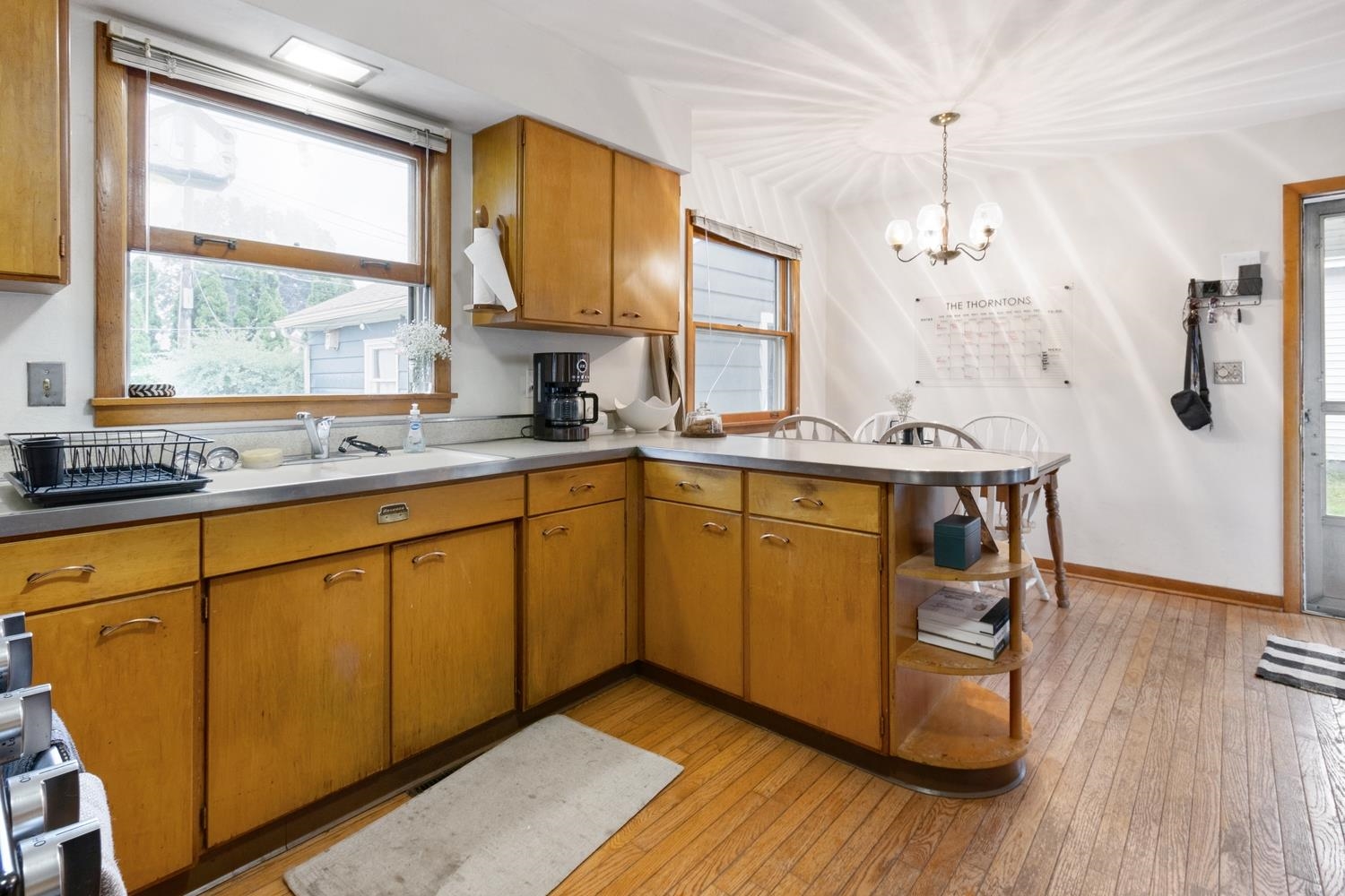 1202 East Le Fevre Road Sterling, IL 61081 - Photo 9 of 20 a kitchen with a sink a window a dining table and stainless steel appliances