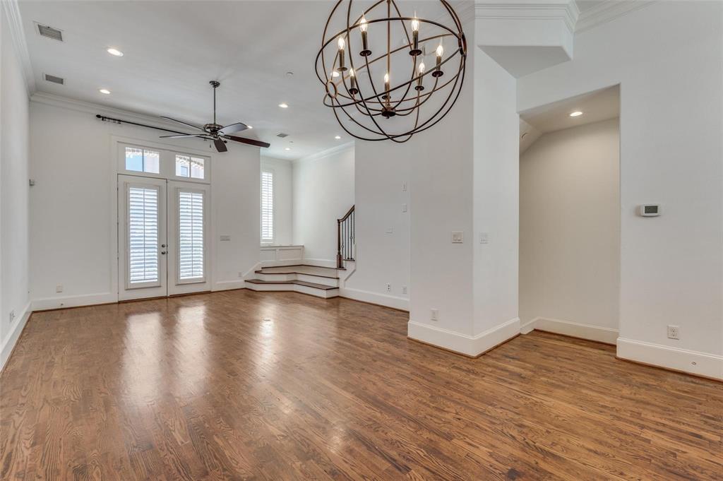 2135 Marilla Street Dallas, TX 75201 - Photo 11 of 23 an empty room with wooden floor and windows