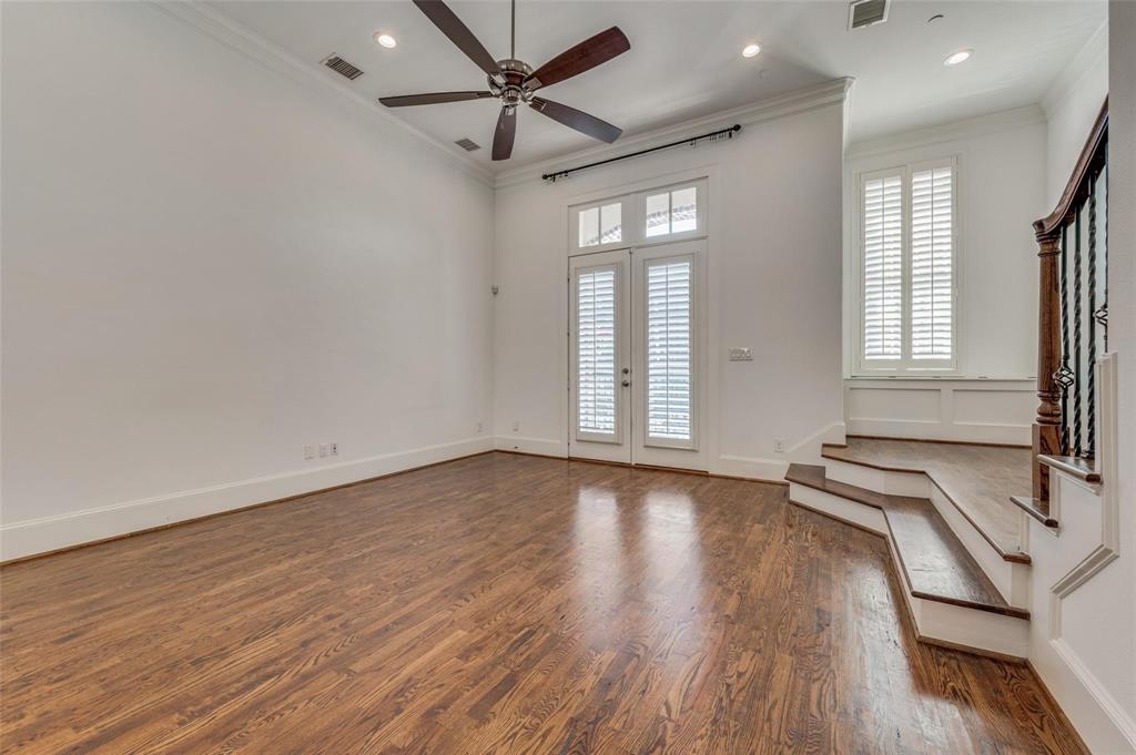 2135 Marilla Street Dallas, TX 75201 - Photo 12 of 23 an empty room with wooden floor and windows