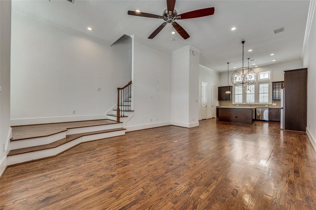 2135 Marilla Street Dallas, TX 75201 - Photo 13 of 23 a view of a room with kitchen island stainless steel appliances wooden floor and window