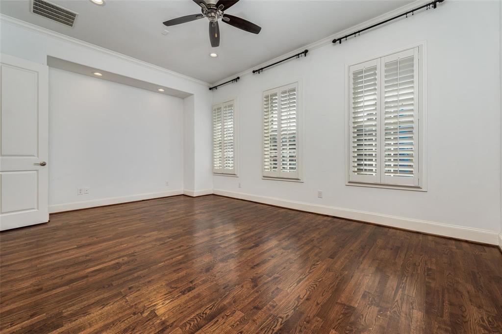 2135 Marilla Street Dallas, TX 75201 - Photo 14 of 23 a view of an empty room with wooden floor and a window
