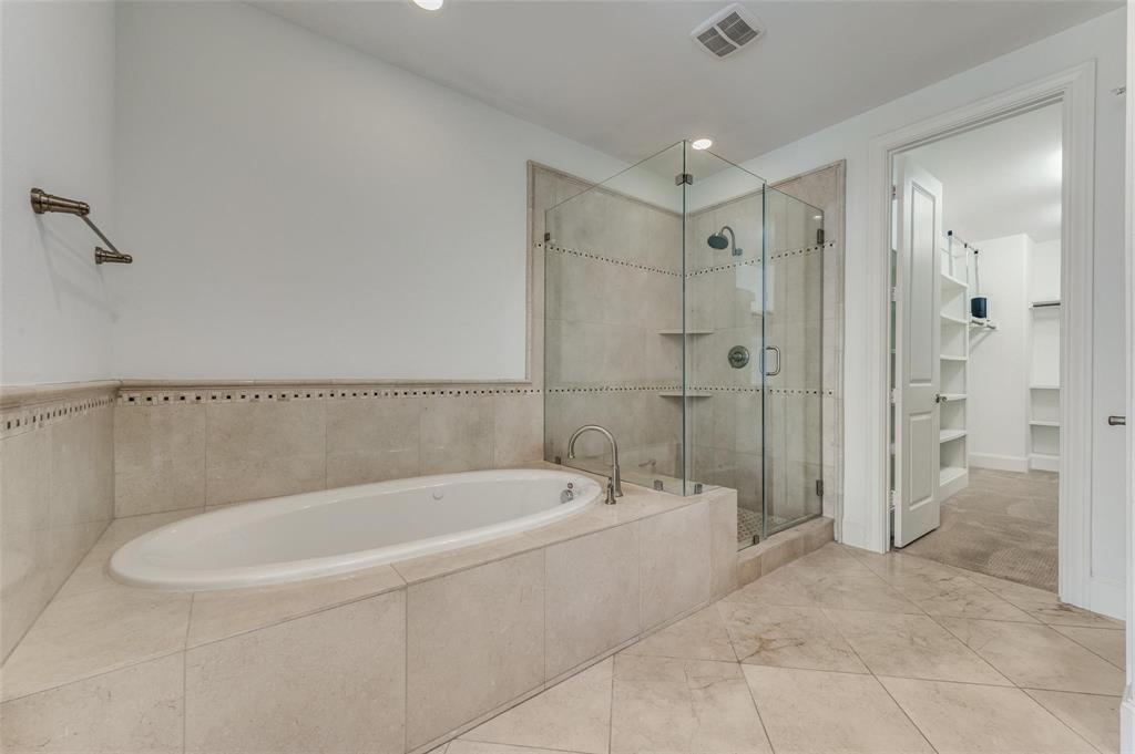 2135 Marilla Street Dallas, TX 75201 - Photo 16 of 23 a spacious bathroom with a bathtub and a shower