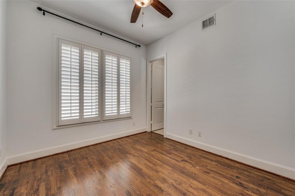 2135 Marilla Street Dallas, TX 75201 - Photo 18 of 23 an empty room with chandelier fan and windows