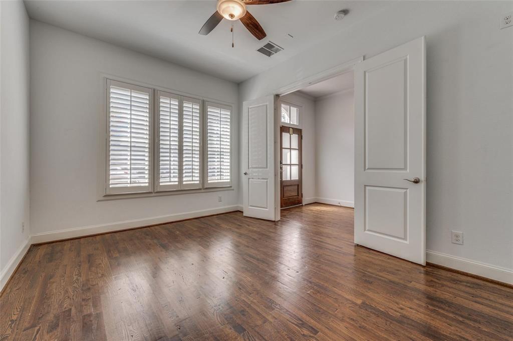 2135 Marilla Street Dallas, TX 75201 - Photo 5 of 23 an empty room with wooden floor and windows
