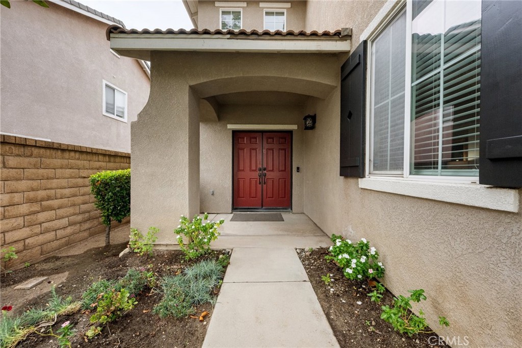 7220 Cumberland Place Rancho Cucamonga, CA 91739 - Photo 3 of 41 Charming covered entry with dual doors and freshly landscaped walkway.