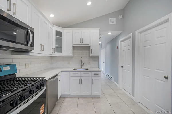a kitchen with stainless steel appliances a stove sink and cabinets