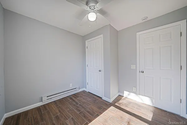 a view of an empty room with wooden floor