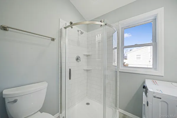 a bathroom with a shower a toilet and a sink