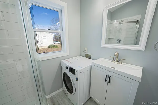 a view of bathroom with a sink and mirror