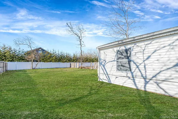 a view of a house with a yard and a garden