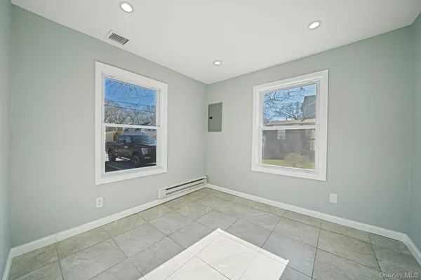 an empty room with windows and closet