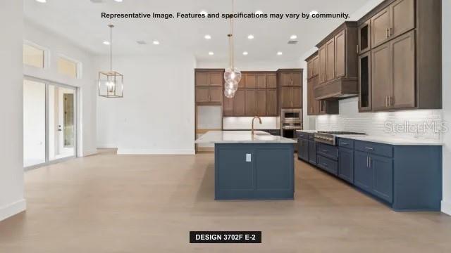 5476 Creek Ridge Road Brooksville, FL 34601 - Photo 6 of 21 a kitchen with stainless steel appliances granite countertop a refrigerator a sink dishwasher and a oven with wooden cabinets