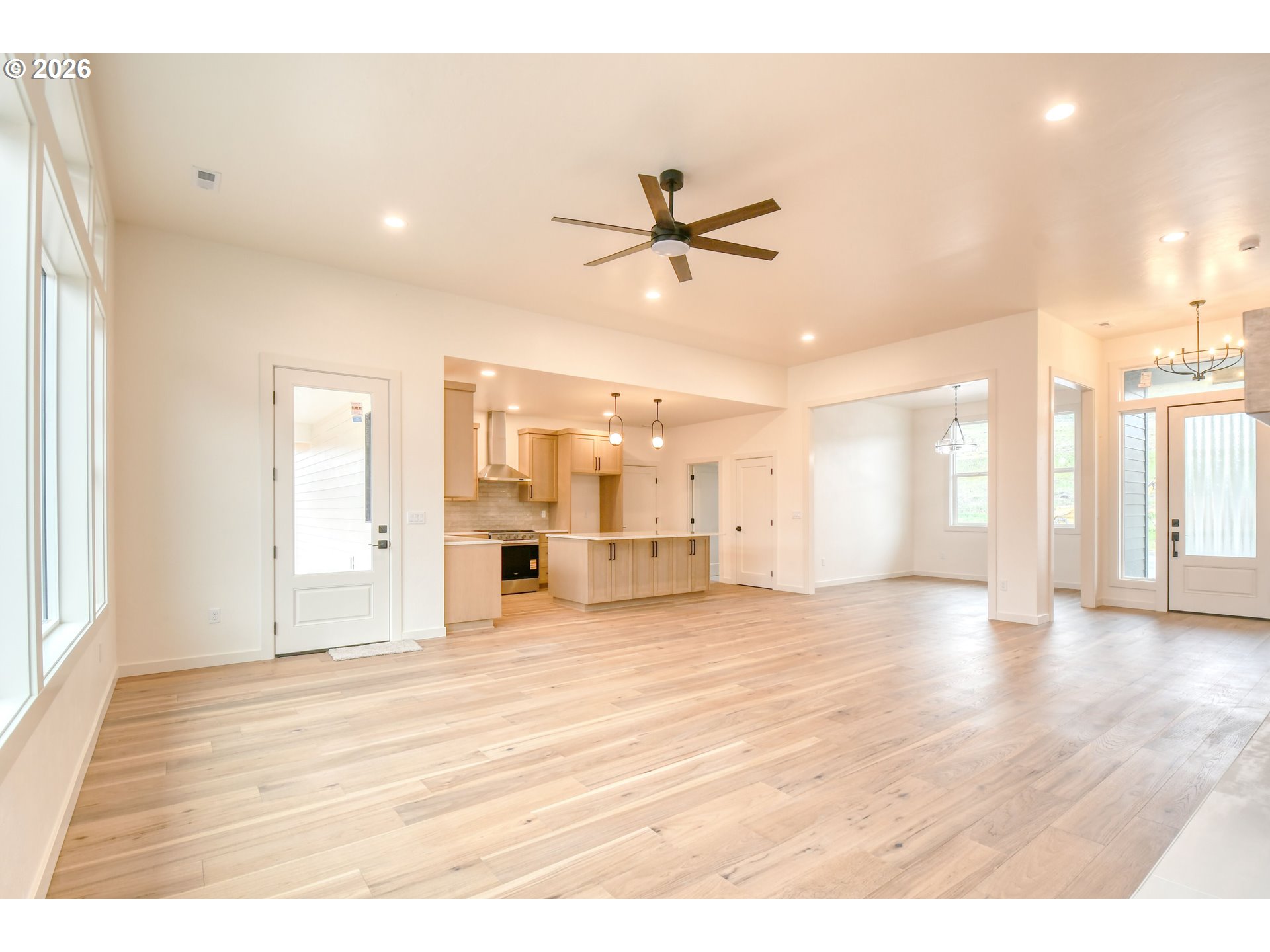 904 Southwest 43rd Street Pendleton, OR 97801 - Photo 10 of 46 a view of a livingroom with a kitchen furniture a ceiling fan and wooden floor
