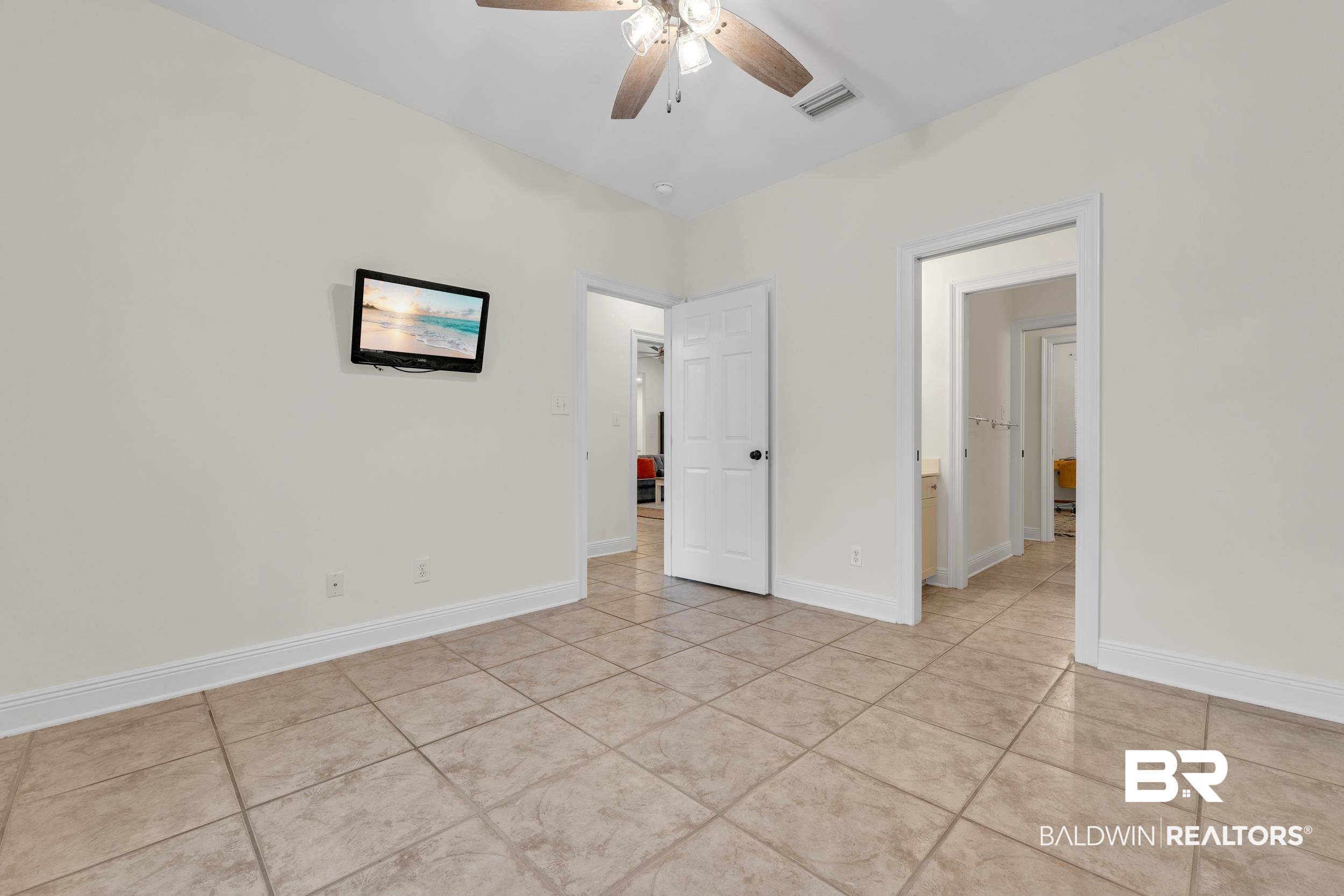 4606 Osprey Drive Orange Beach, AL 36561 - Photo 36 of 44 Guest Bedroom number 2 featuring light tile patterned floors, ceiling fan, and a jack and Jill bathroom with 2 private water closets.