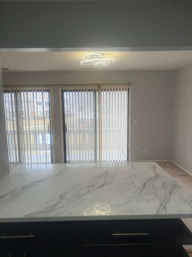 287 Pembridge Lane, Unit B2 Schaumburg, IL 60193 - Photo 5 of 13 a view of an empty room and window