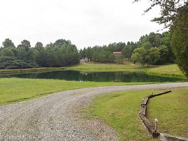 2040 Dodgetown Road Walnut Cove, NC 27052 - Photo 3 of 11 Entry. View across the pond after you enter the property up to the homesite