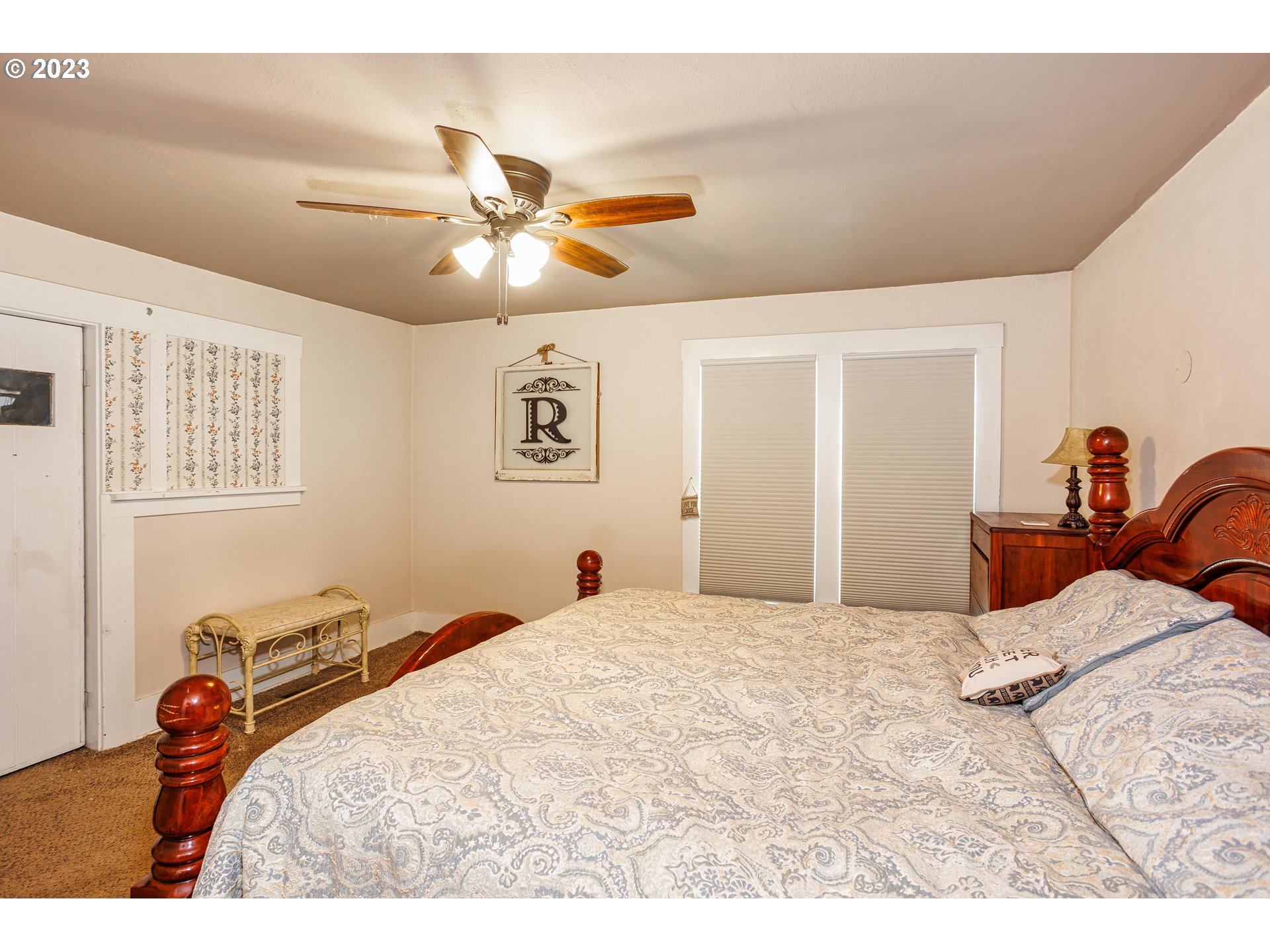 116 South 4th Avenue Ridgefield, WA 98642 - Photo 14 of 31 a bedroom with a bed and a chandelier