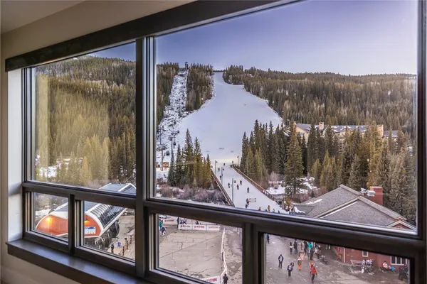 a view of a balcony with wooden floor and iron stairs