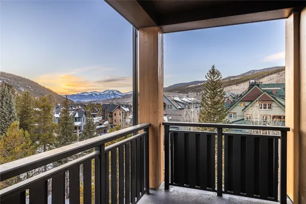 a view of a balcony with wooden floor and fence