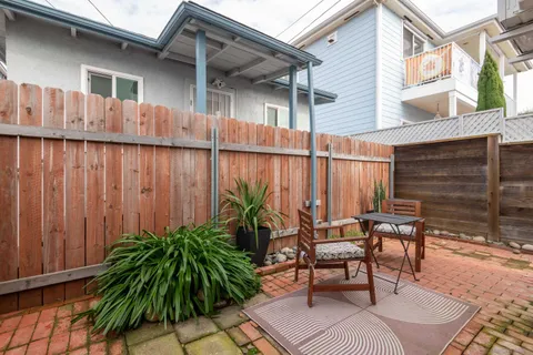 a backyard of a house with table and chairs