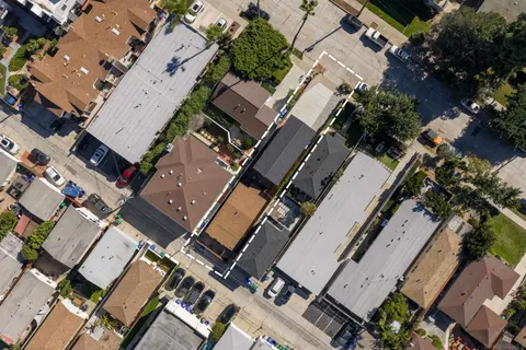 an aerial view of a house with a yard