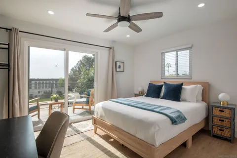 a bedroom with a large bed and a balcony