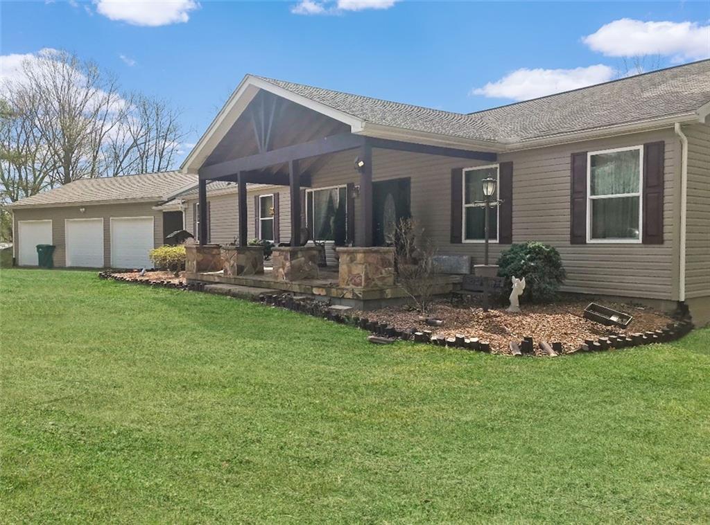 5586 County Line Road New Castle, PA 16101 - Photo 1 of 3 a front view of a house with garden