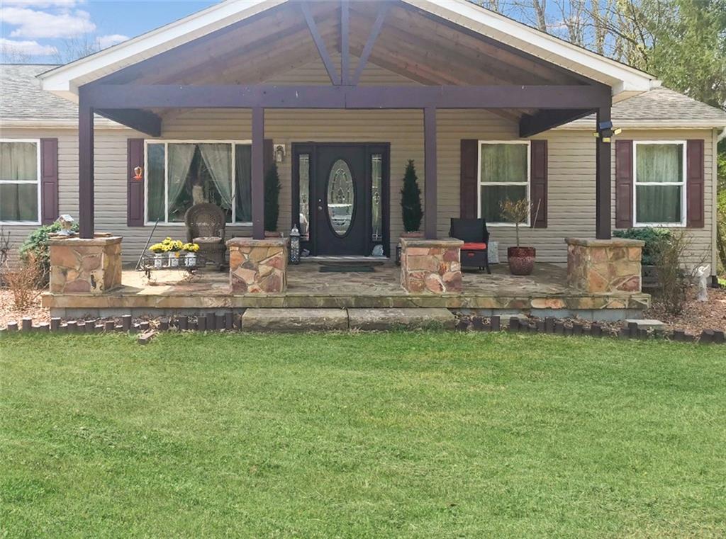5586 County Line Road New Castle, PA 16101 - Photo 2 of 3 a view of house with backyard and outdoor seating